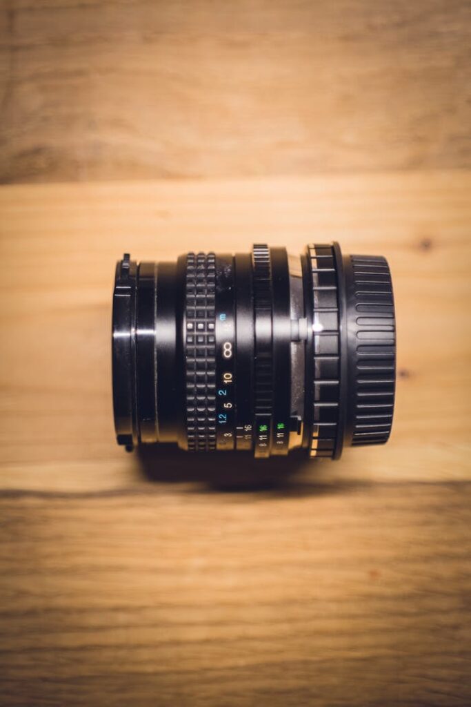 Black Camera Lens on Brown Wooden Table